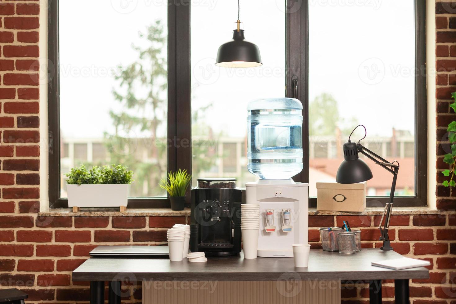 Cerca del dispensador de agua y máquina de café en la mesa en la oficina de reuniones foto