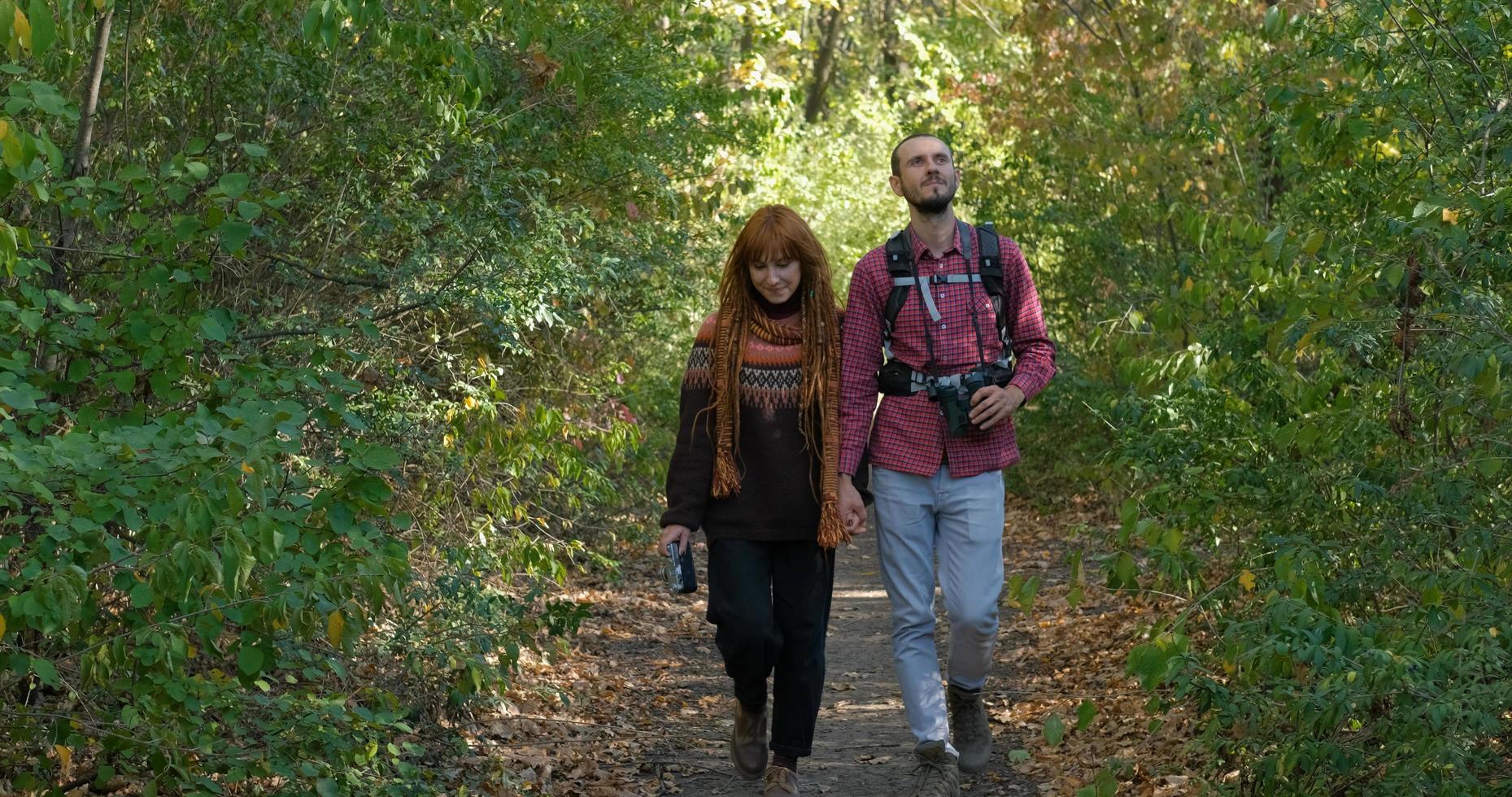 couple of travelers  in autumn forest photo