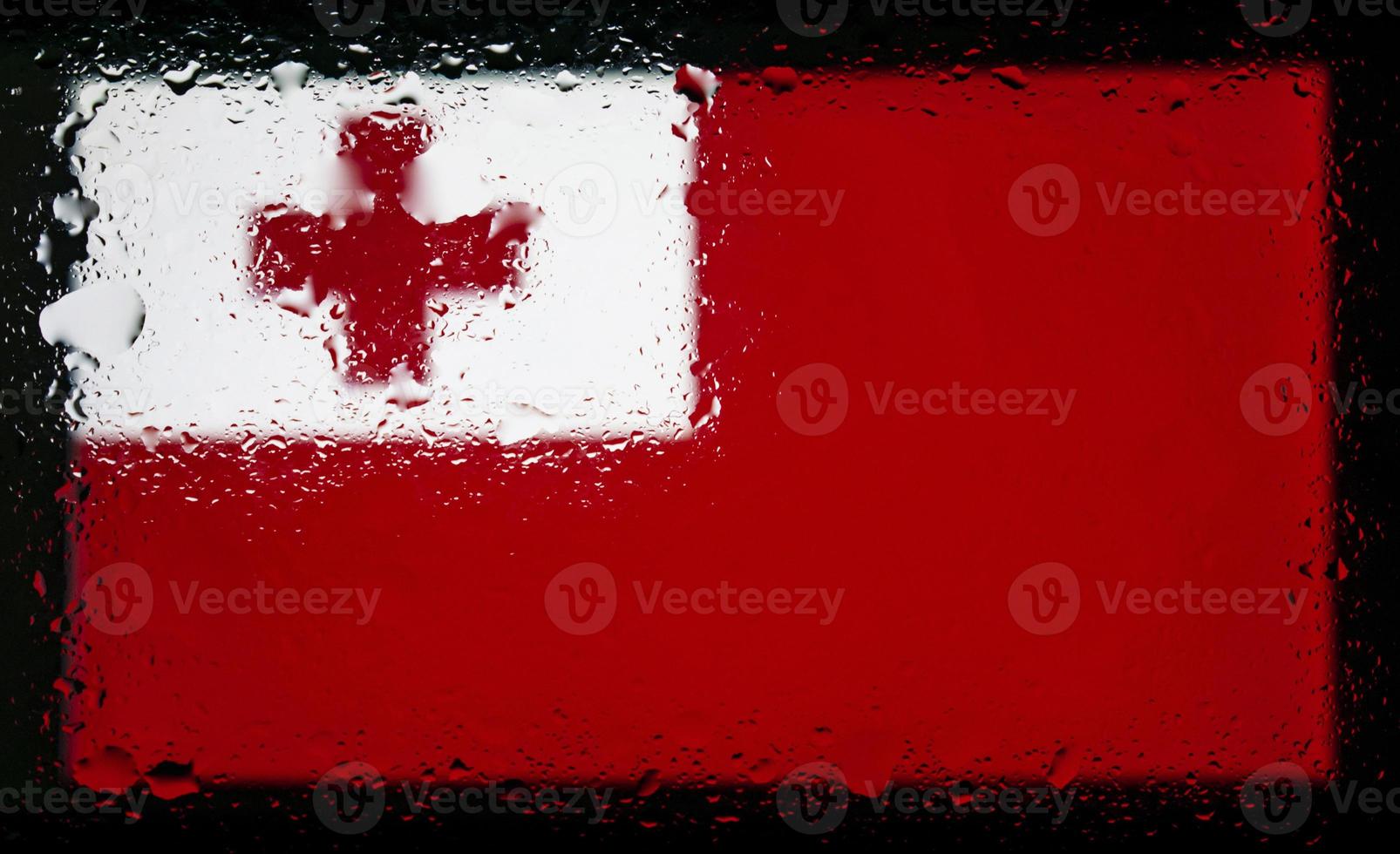 Drops of water on Tonga flag background. Shallow depth of field. Selective focus. Toned. photo