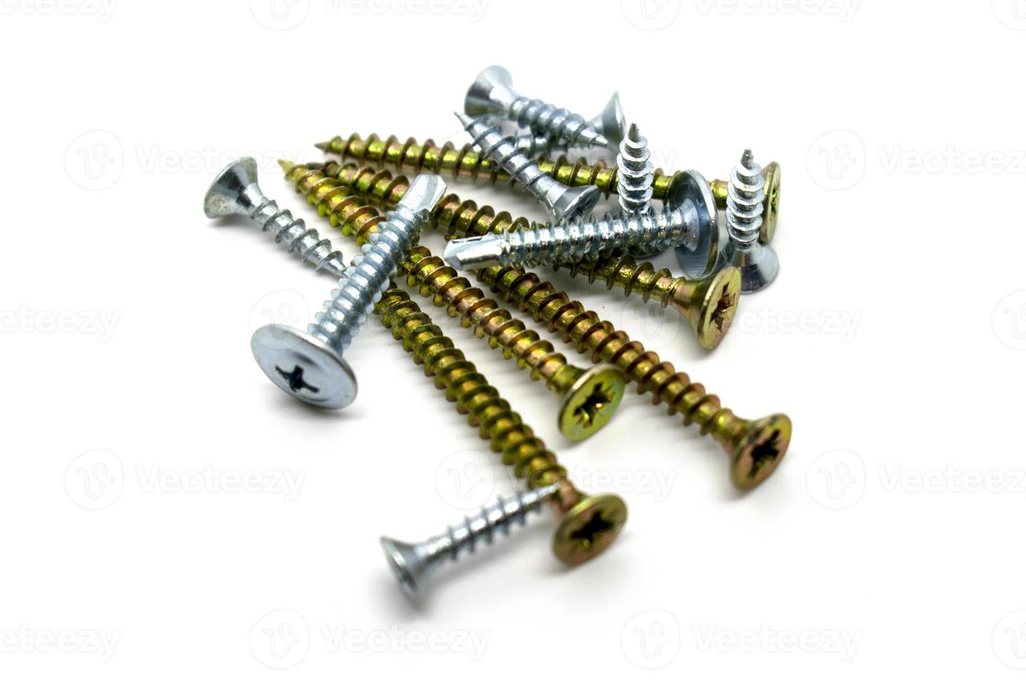 A set of various chromed screws isolated on white background photo