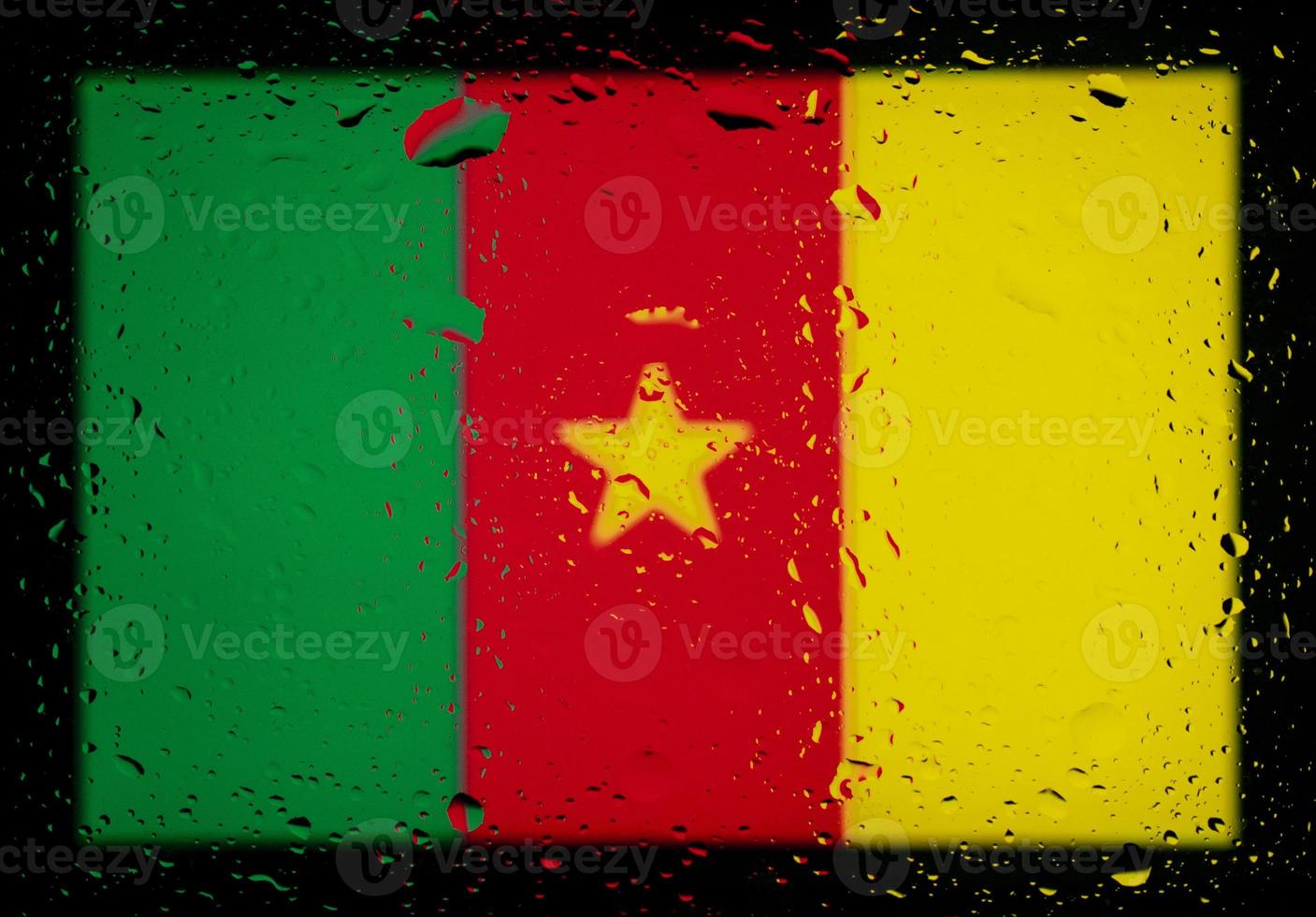 Drops of water on Cameroon flag background. Shallow depth of field. Selective focus. Toned. photo