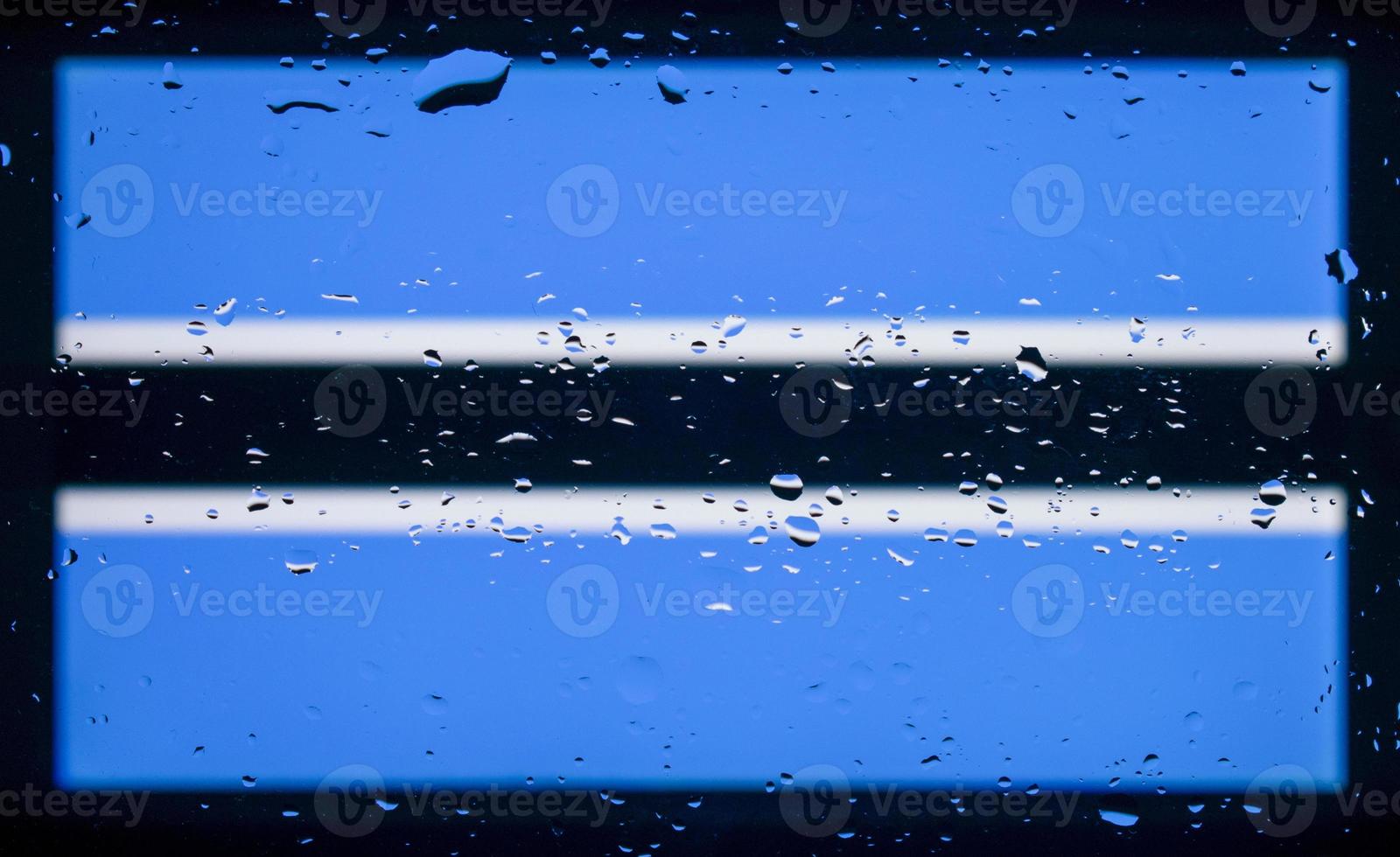 Drops of water on Botswana flag background. Shallow depth of field. Selective focus. Toned. photo