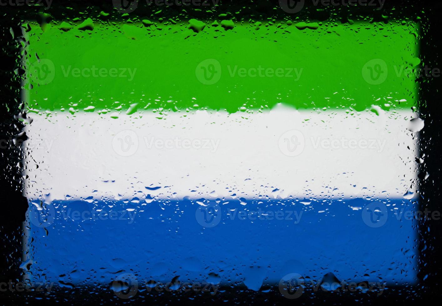 Drops of water on sierra leone flag background. Shallow depth of field. Selective focus. Toned. photo