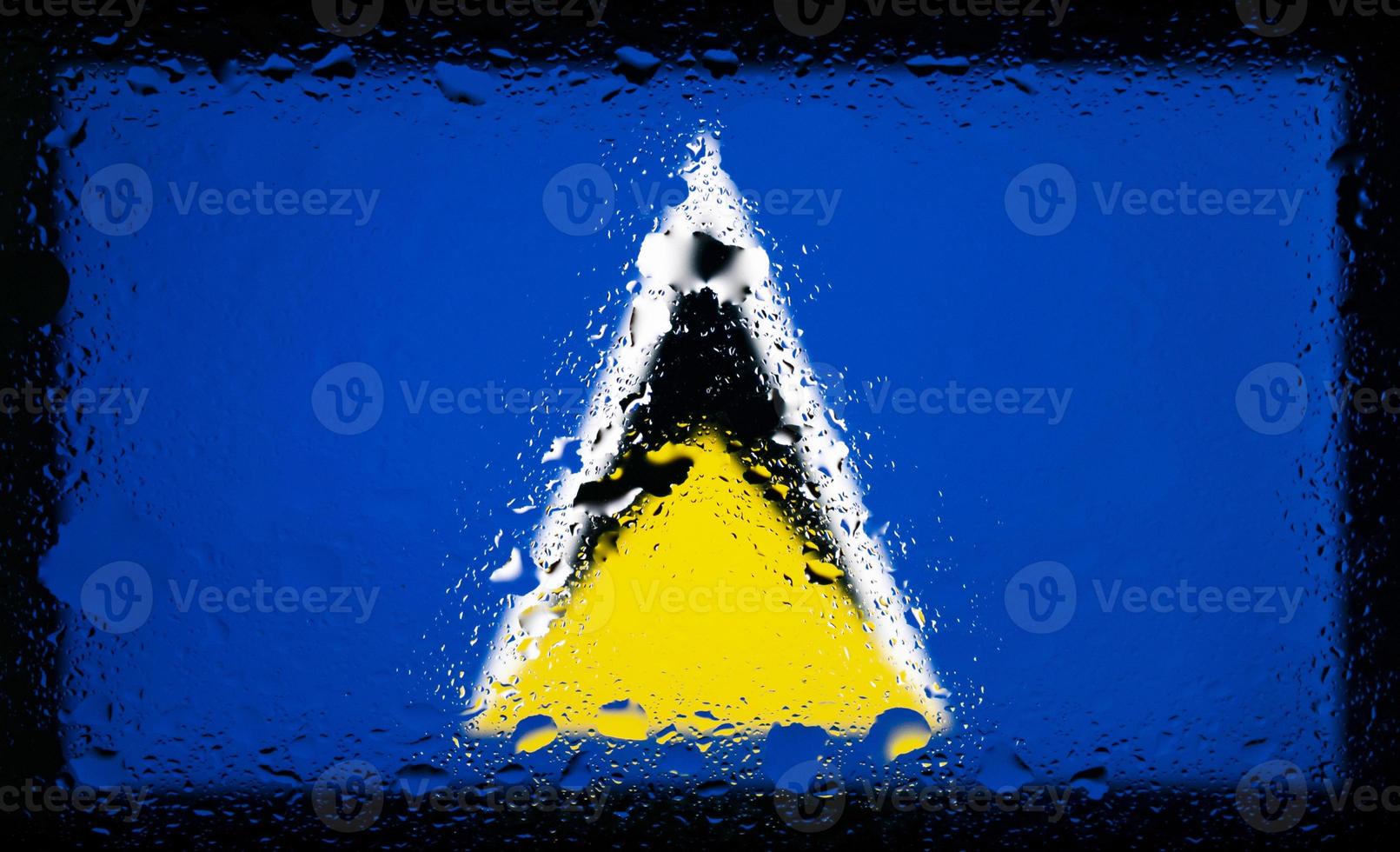 Drops of water on Saint Lucia and Nevis flag background. Shallow depth of field. Selective focus. Toned. photo