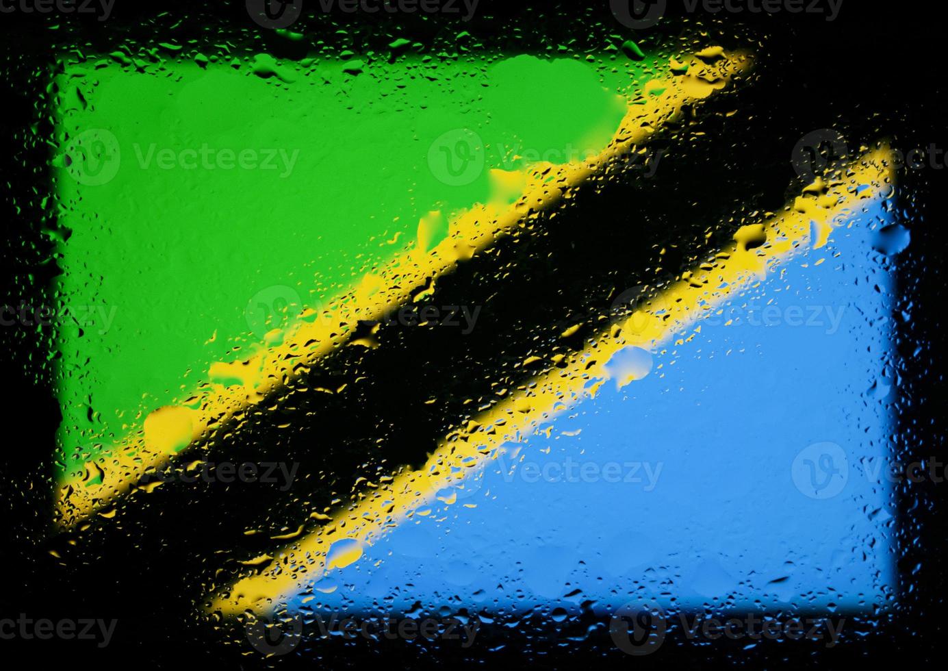 Drops of water on Tanzania flag background. Shallow depth of field. Selective focus. Toned. photo