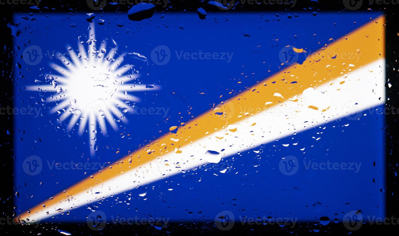 Drops of water on Marshall Islands flag background. Shallow depth of field. Selective focus. Toned. photo