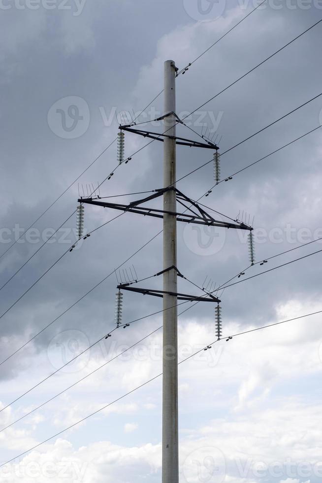 Pilar y líneas eléctricas contra un cielo nublado foto