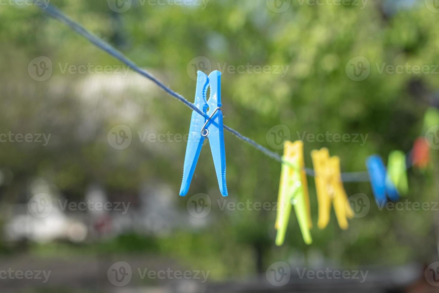 Colorful clothespins on the rope. photo