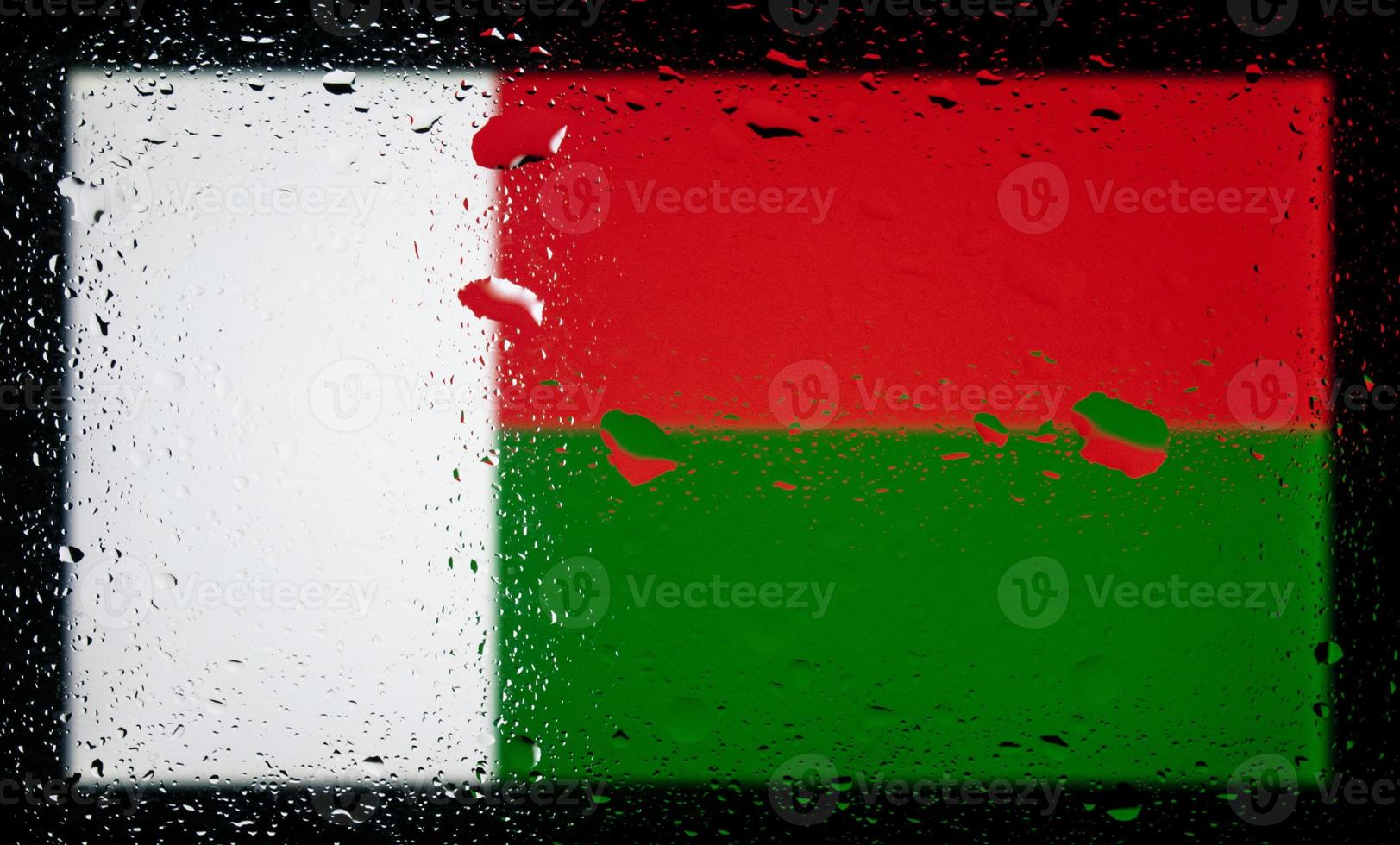 Drops of water on Madagascar flag background. Shallow depth of field. Selective focus. Toned. photo