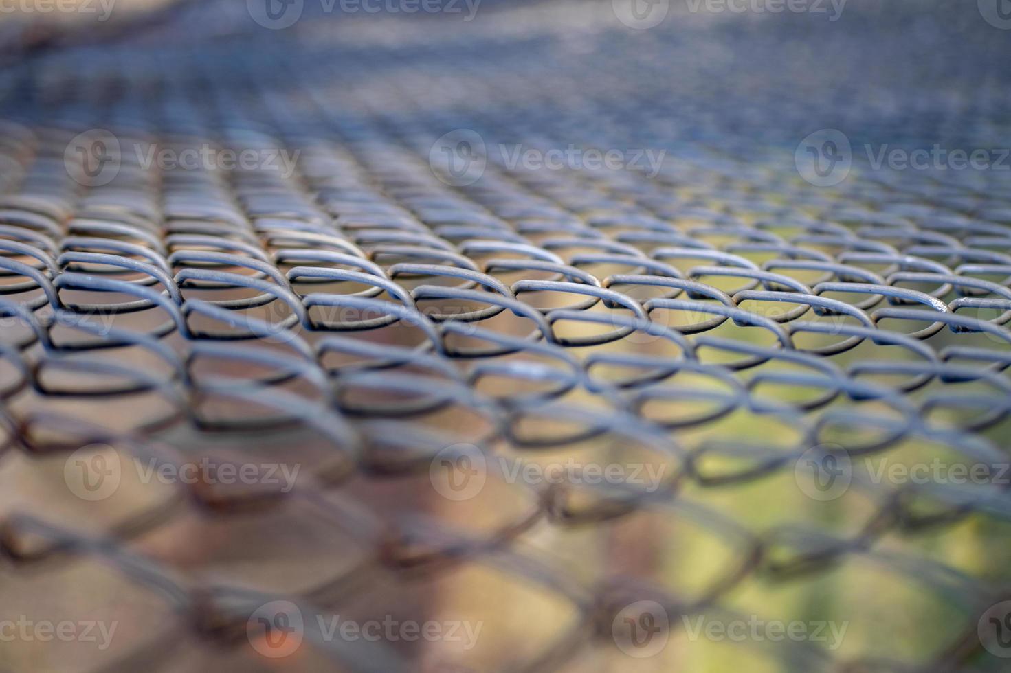 Iron mesh netting with colored bokeh background photo
