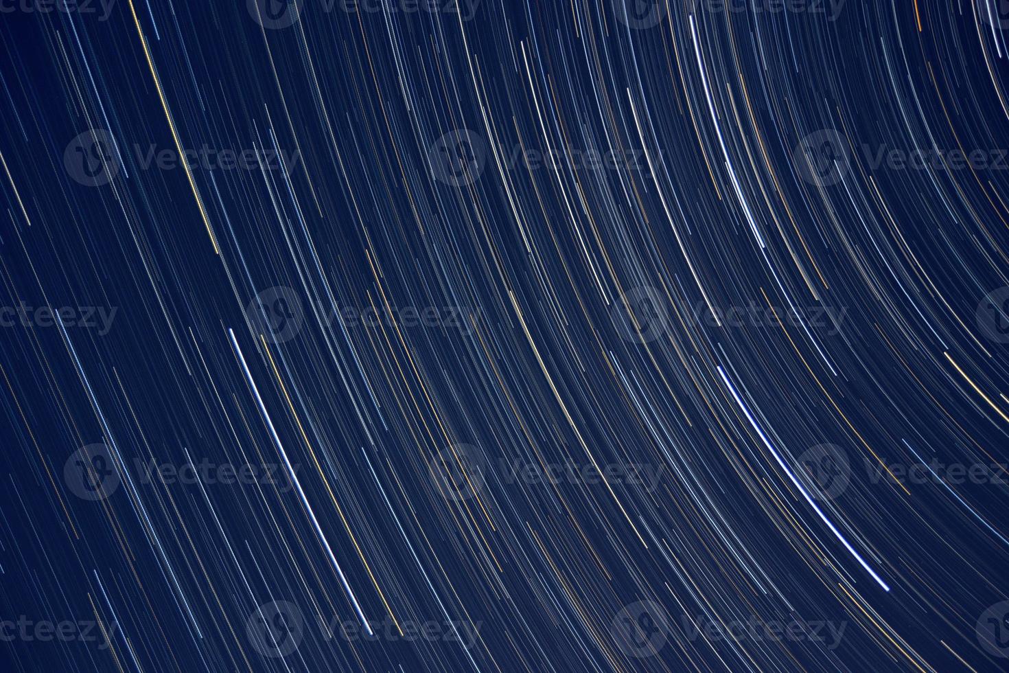 Star trails, vision of the stars that rotate in the firmament photo