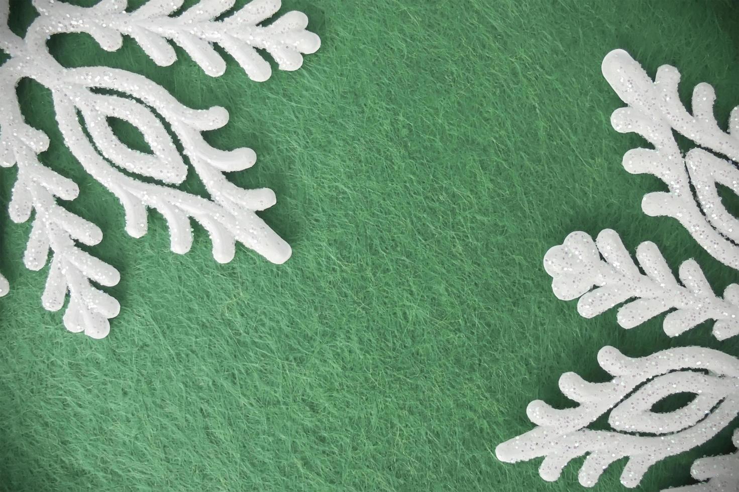 green-gray felt background with white snowflakes with sparkles. christmas background photo