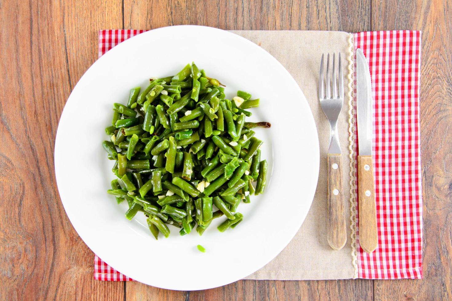 Green Beans Fried with Garlic on a White Plate. photo