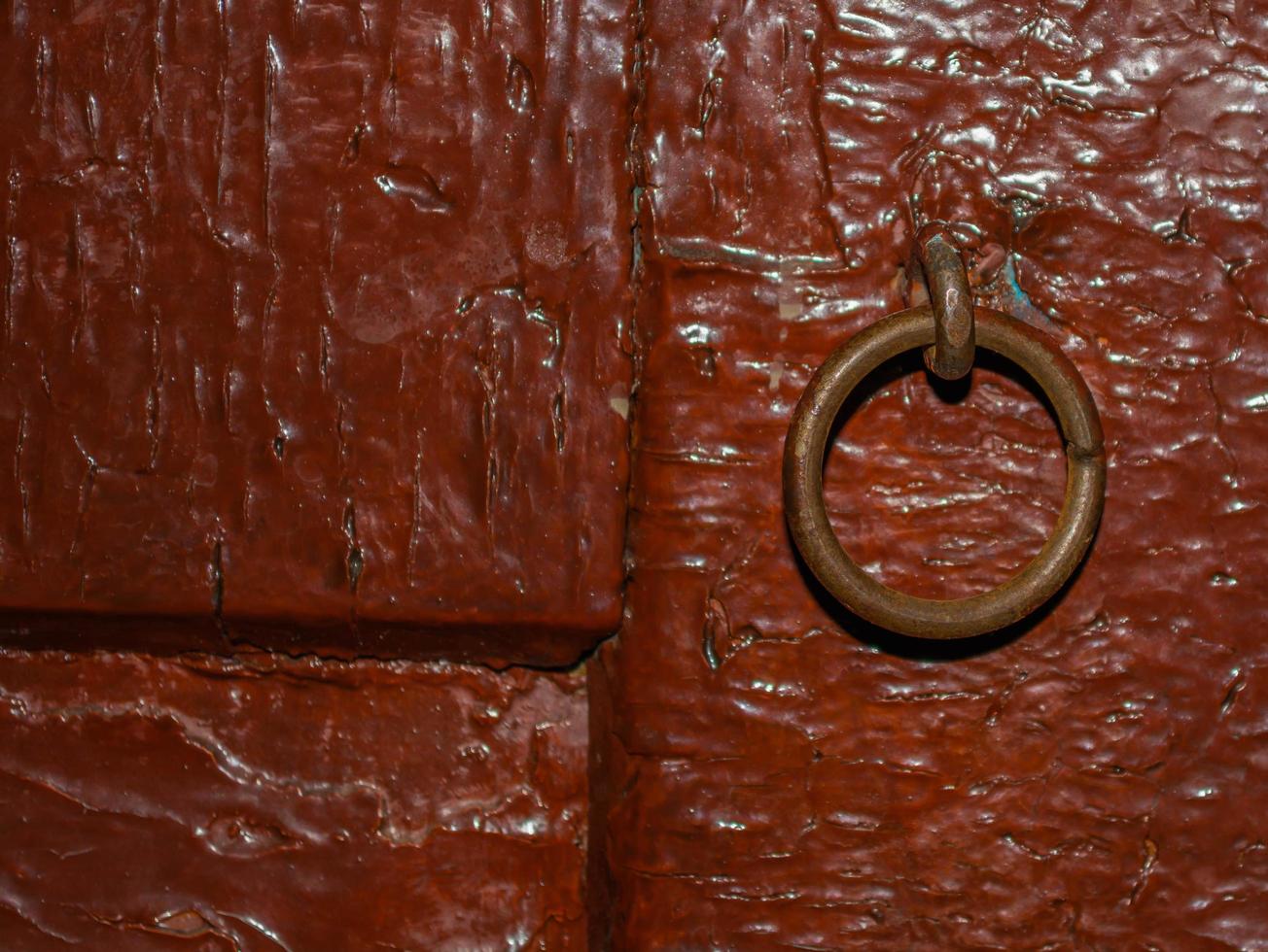 Padlock ring in old red door. photo