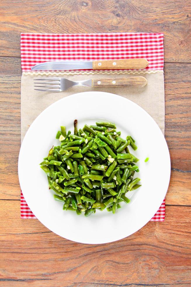 Green Beans Fried with Garlic on a White Plate. photo