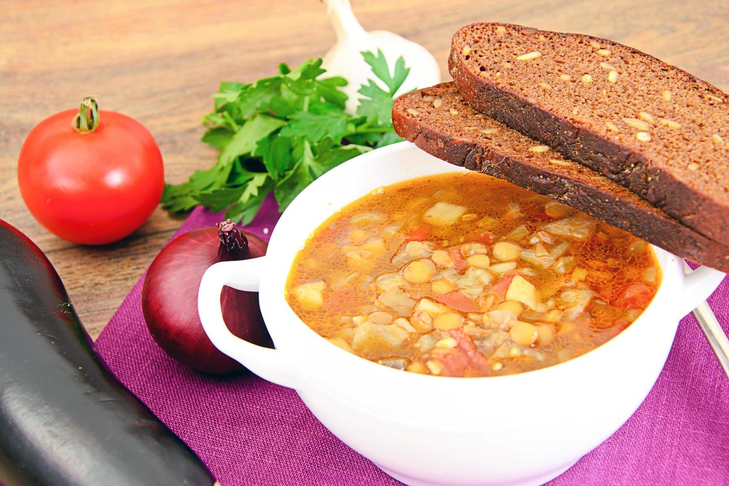 Lentil soup with eggplant, tomatoes and onions photo