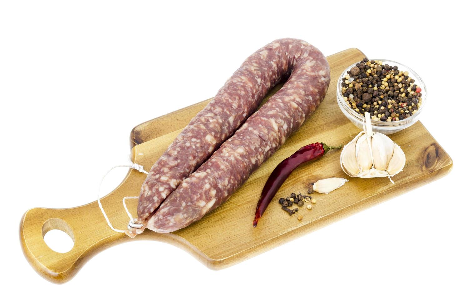 Homemade pork dried cured sausage on white background. photo