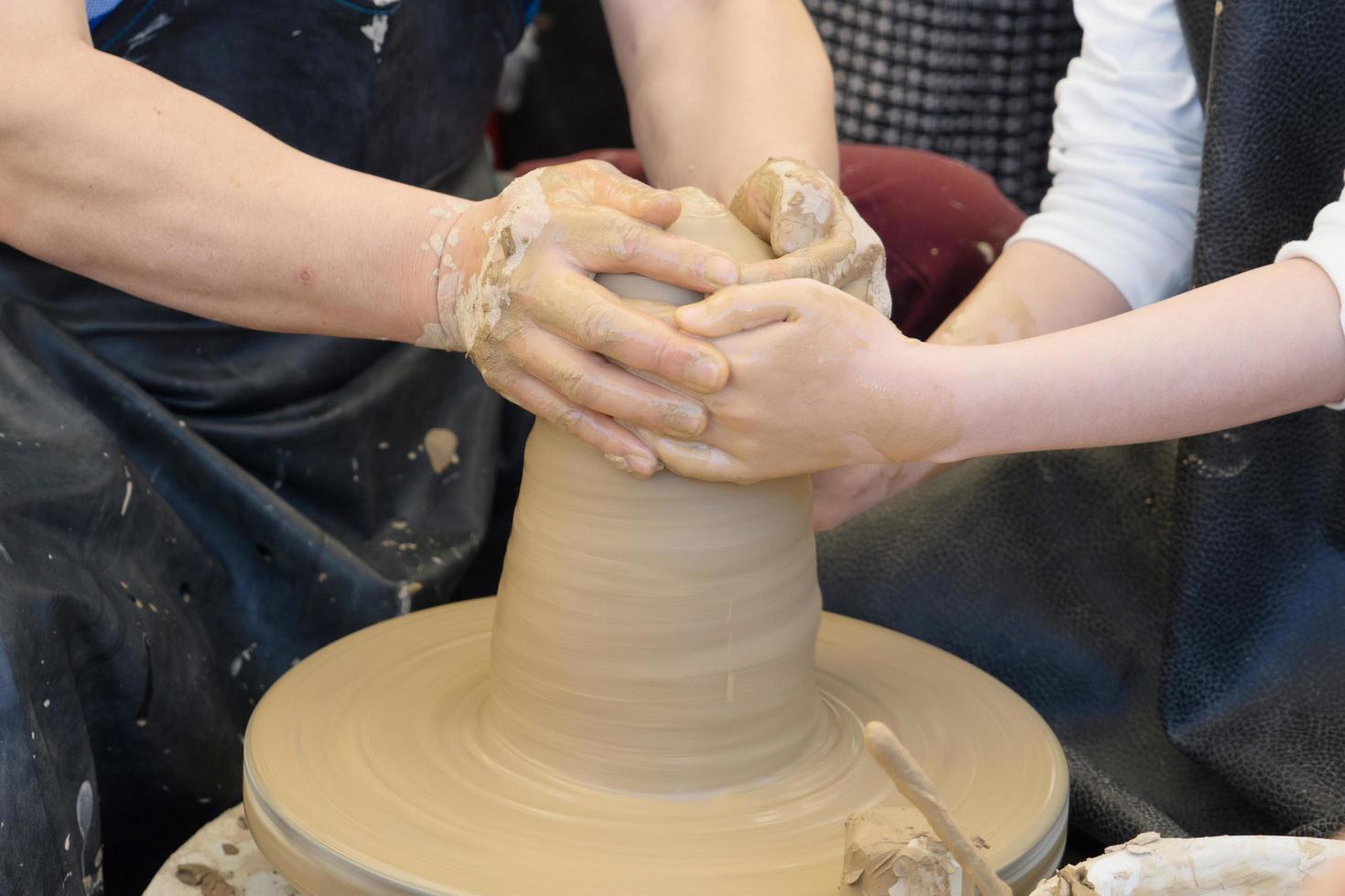 close up of hands make pottery photo