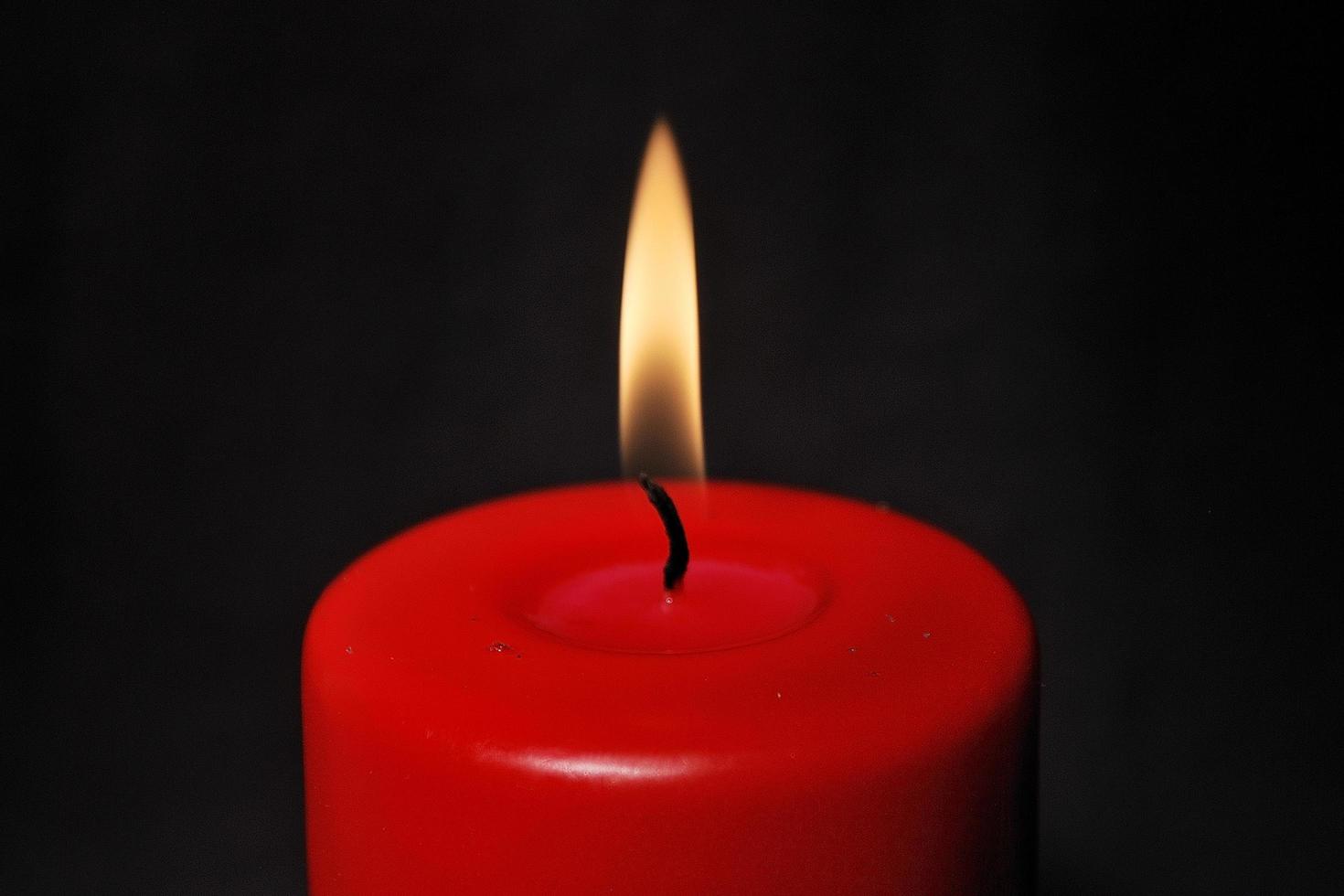 red candle with black background photo