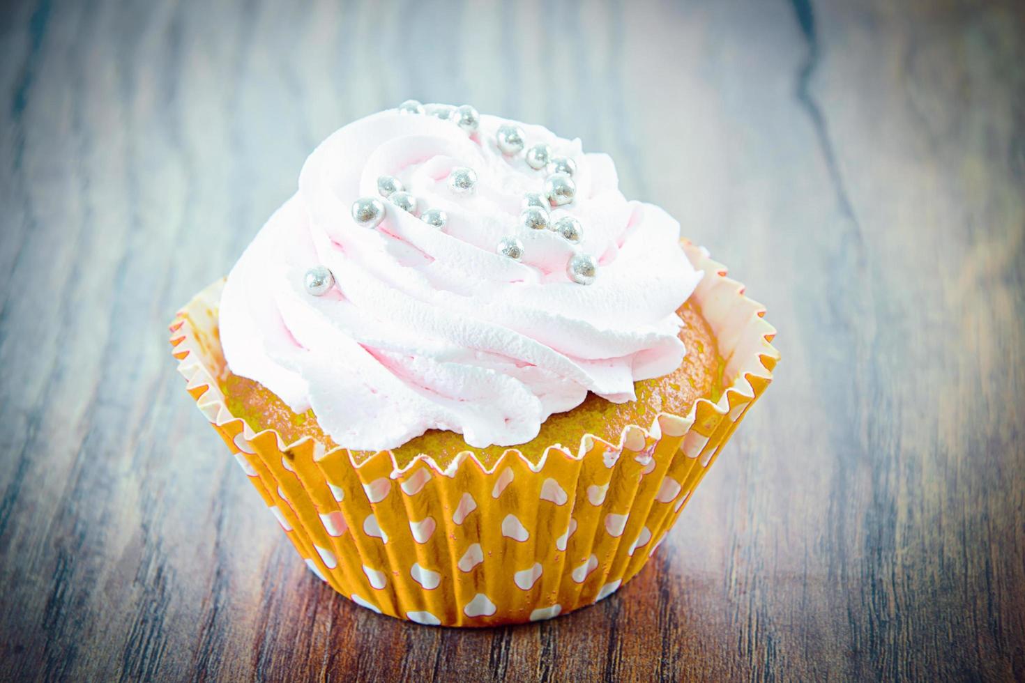 Cake with Cream, Cupcake on Woody Background. photo