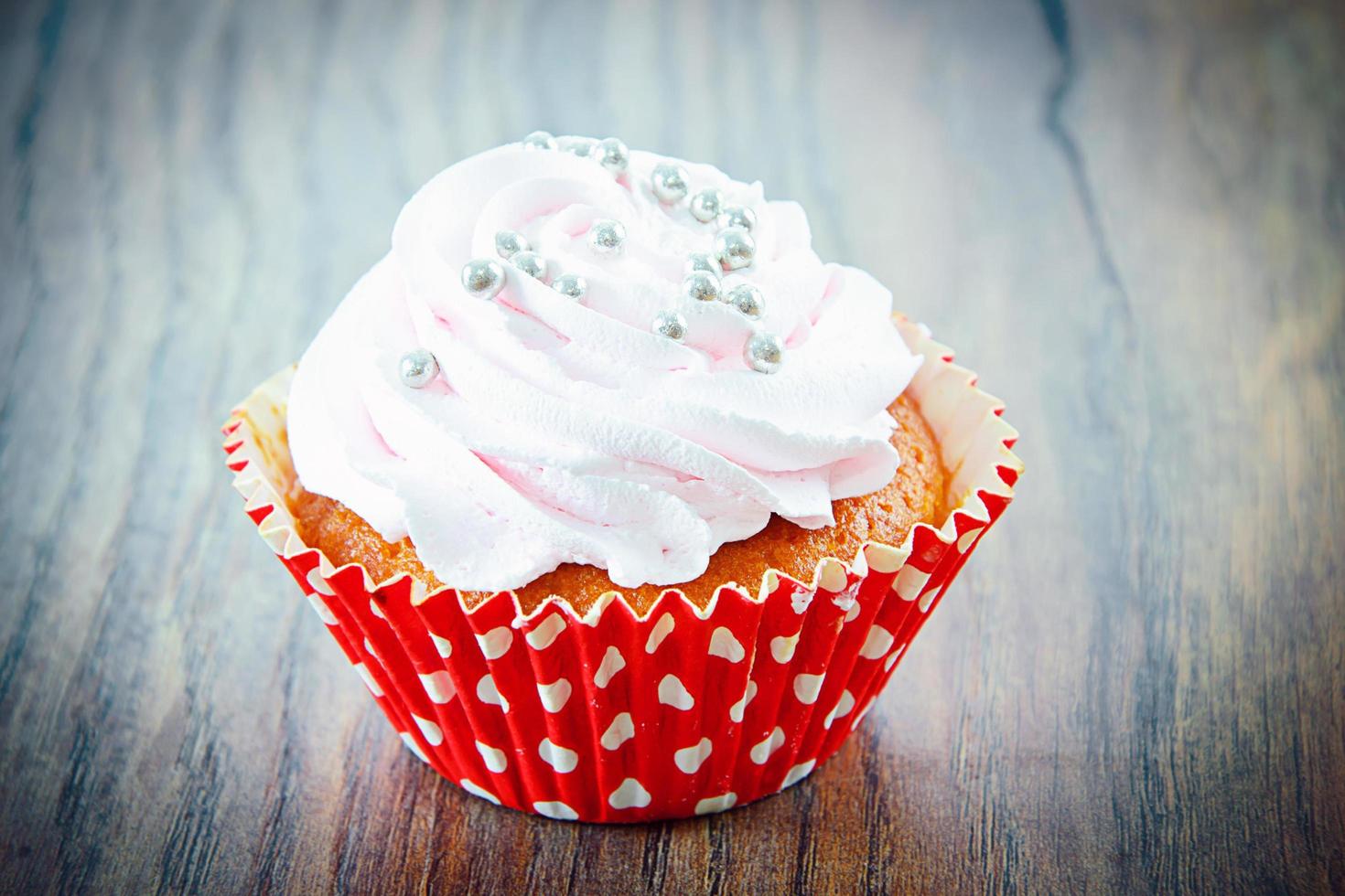 Cake with Cream, Cupcake on Woody Background. photo