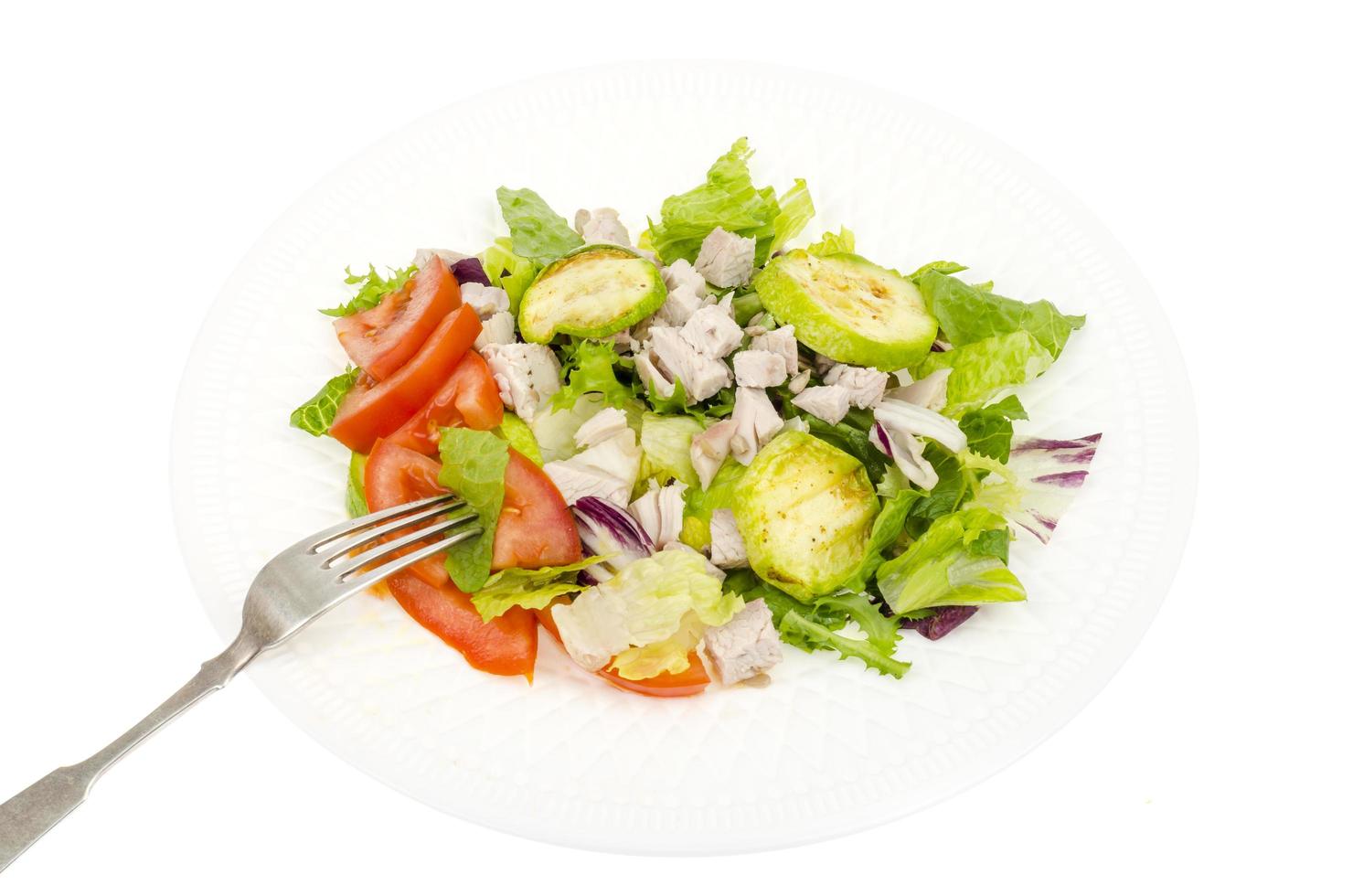 Dietary food, salad leaves with zucchini slices, tomatoes and slices of turkey fillet photo