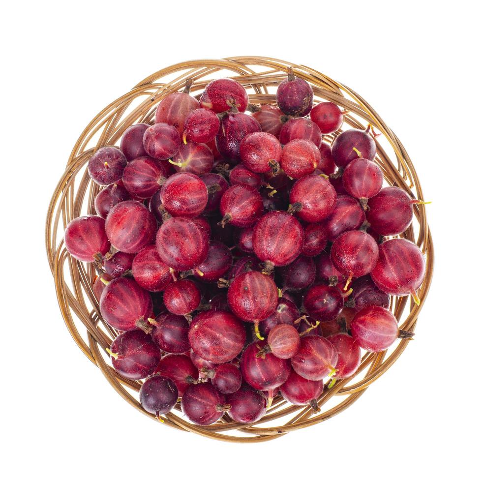 Fresh berries of red gooseberries in bowl on white background. photo