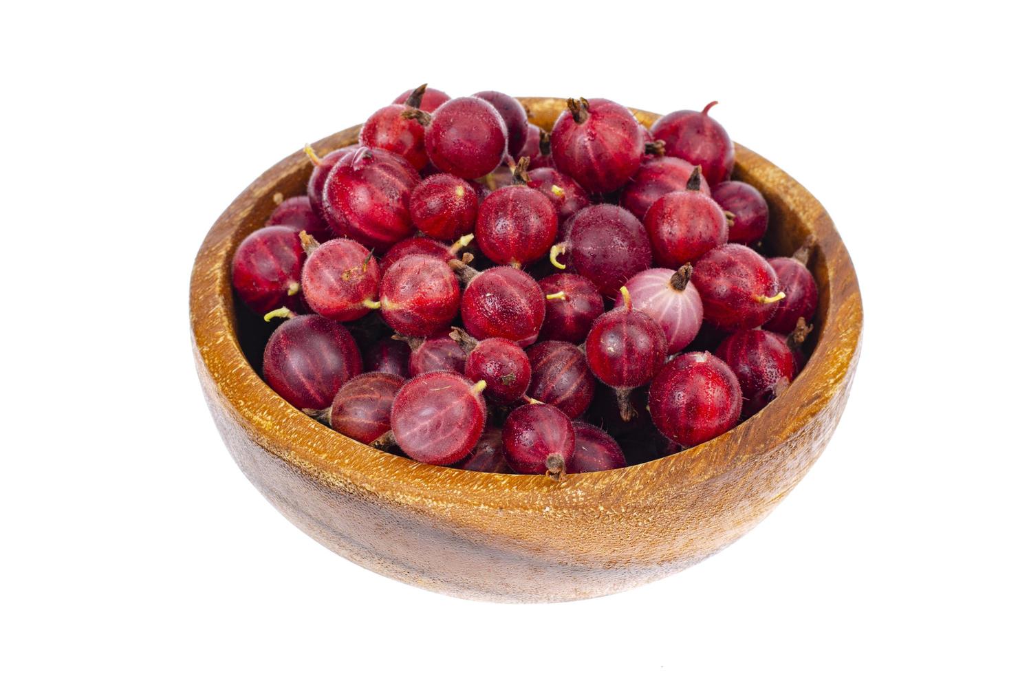 Fresh berries of red gooseberries in bowl on white background. photo