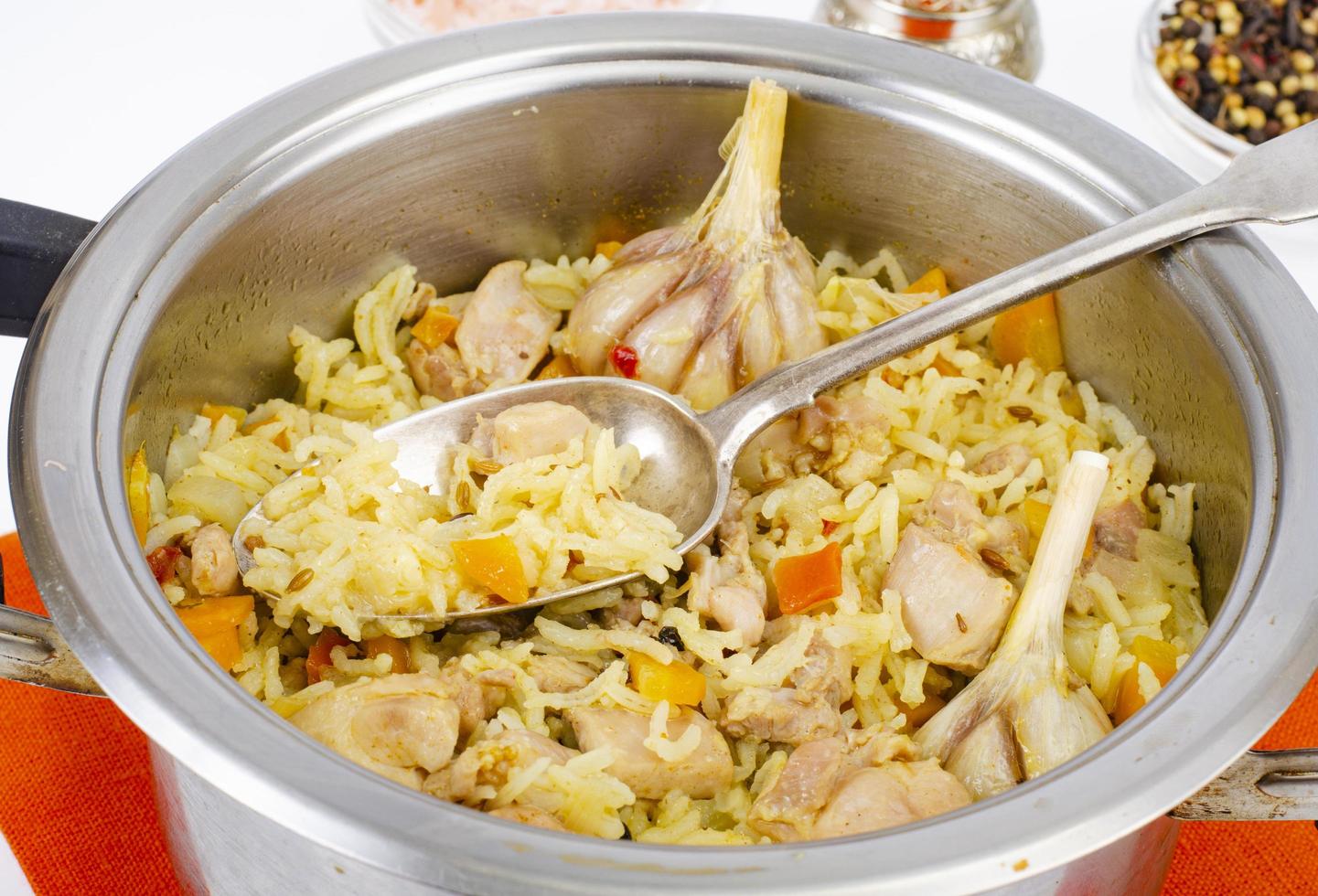 Pilaf with rice and meat in saucepan. photo