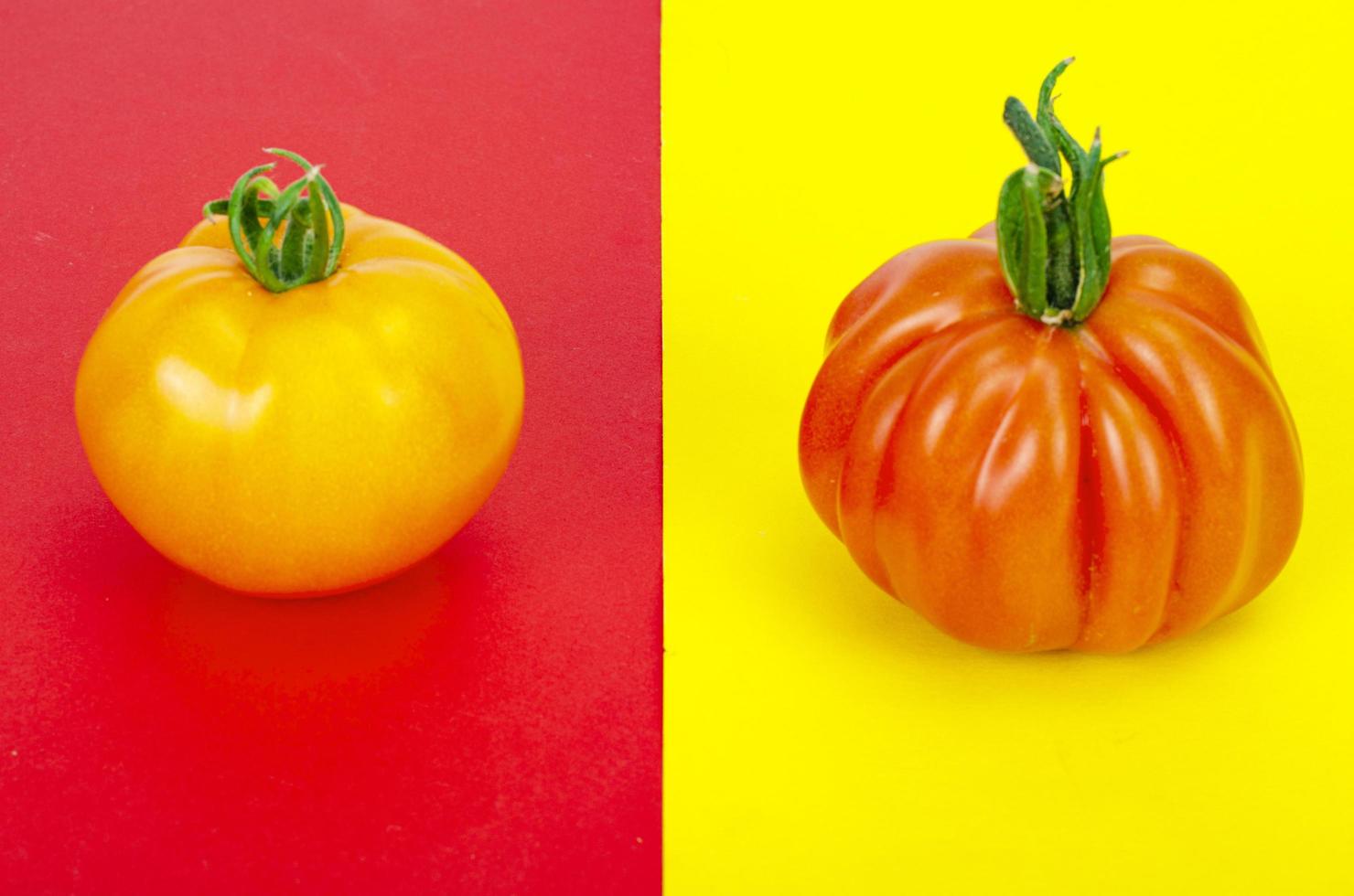 Bright background with tomatoes on red and yellow background. photo