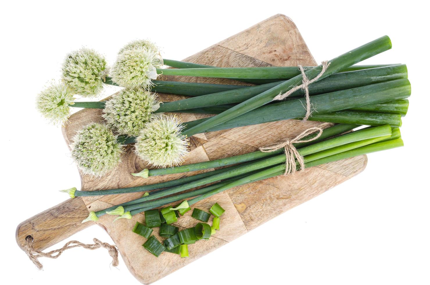 Fresh cut green onion arrows isolated on white photo