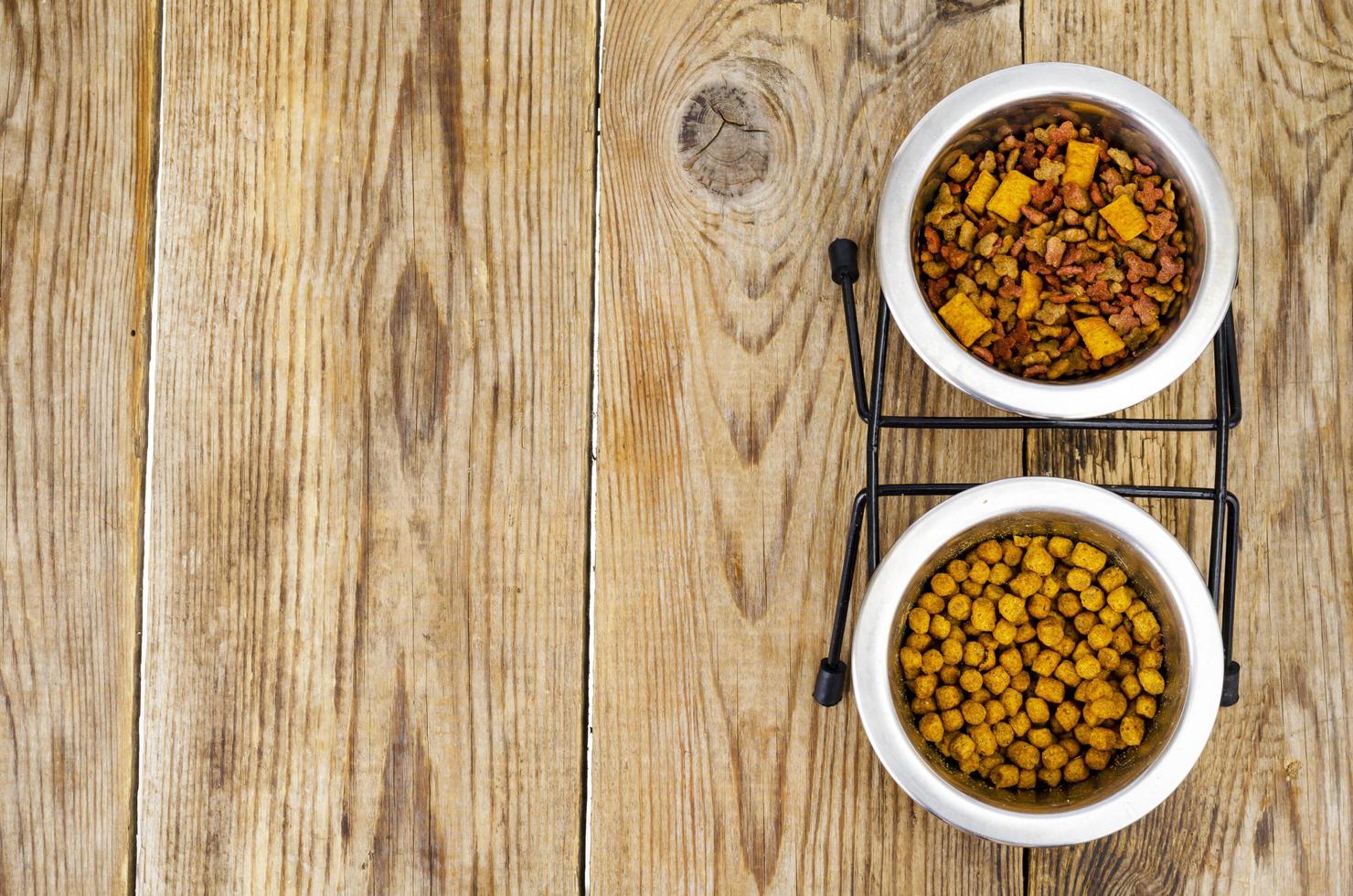Granular pet food on brown wood background. photo