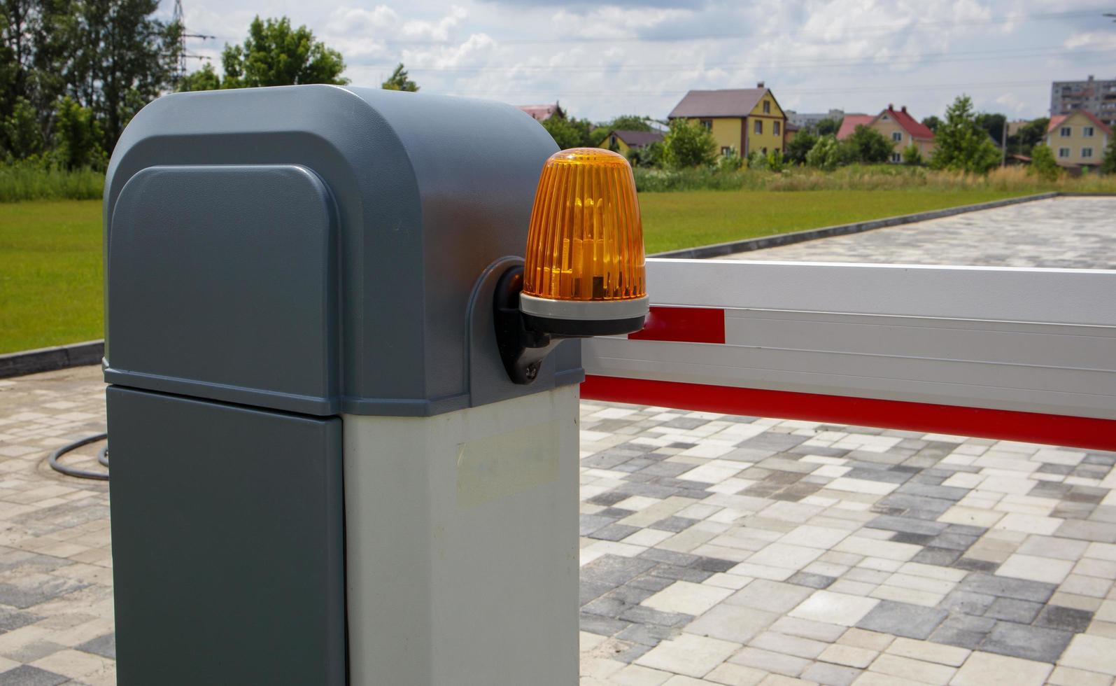 Close the gate. Automatic security system. Automatic entry system. Yellow light signal with a street barrier. Barrier gates Automatic security system. photo