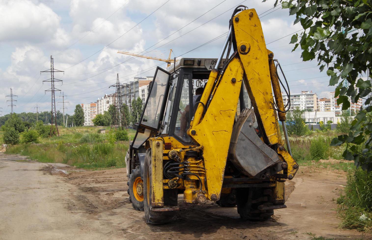 excavadora en un sitio de construcción con el telón de fondo del cielo. maquinaria pesada en el trabajo. un gran vehículo de construcción amarillo en un sitio de construcción. imagen industrial. foto