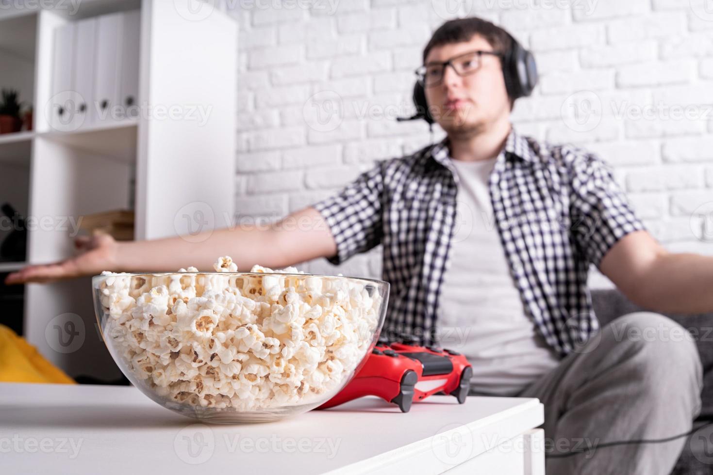 Disappointed young man playing video games at home photo