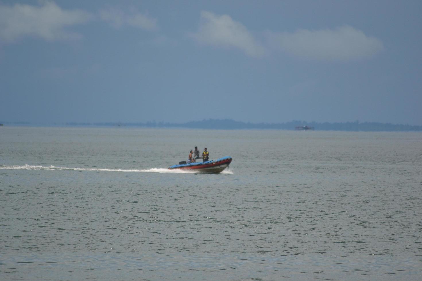 Sorong, West Papua, Indonesia, 2021. Villager crossing the sea with wooden boat. photo