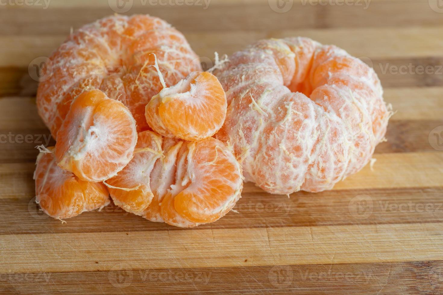 Oranges on a wooden board photo