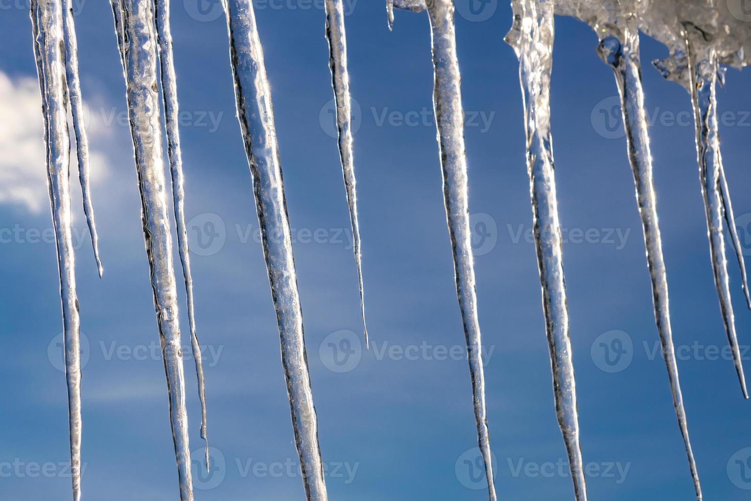 Icicles hanging from the roof photo
