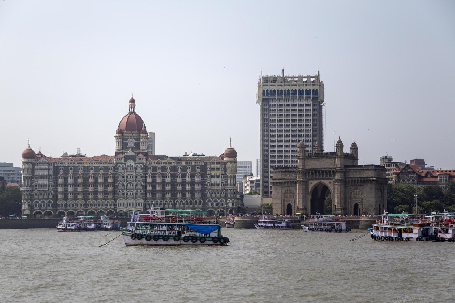 MUMBAI, INDIA, OCTOBER 11, 2015 - Boats in front of the Taj Mahal Palace Hotel. This 5 star hotel is considered the flagship property of the group and contains 560 rooms and 44 suites. photo