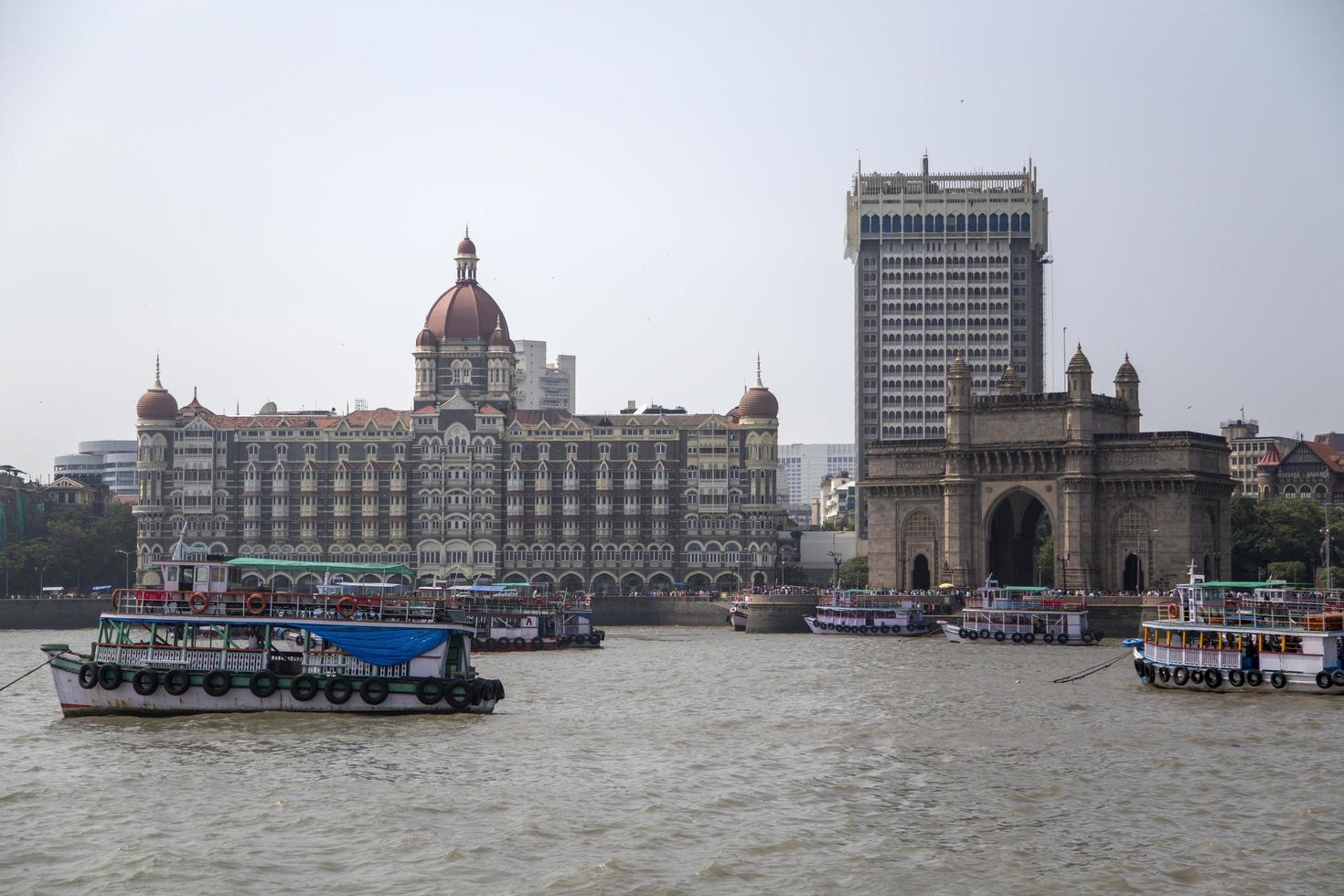 MUMBAI, INDIA, OCTOBER 11, 2015 - Boats in front of the Taj Mahal Palace Hotel. This 5 star hotel is considered the flagship property of the group and contains 560 rooms and 44 suites. photo