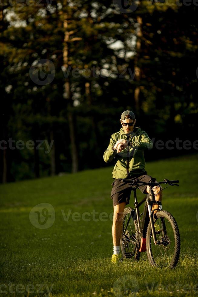 Young man riding ebike in the park photo