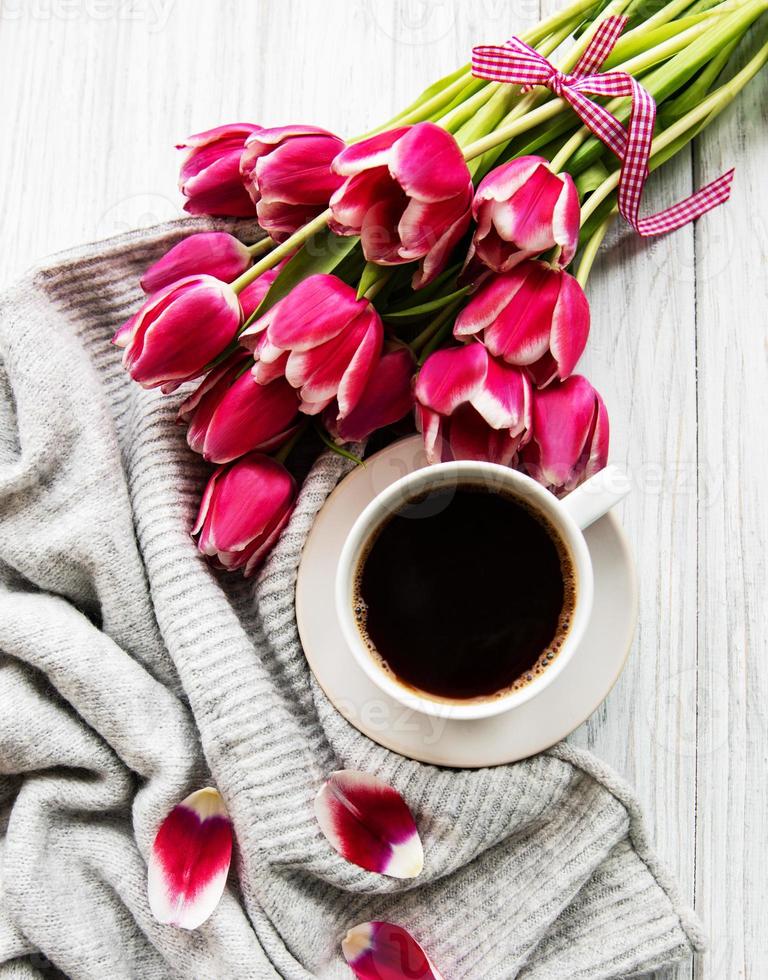 Cup of coffee and pink tulips photo