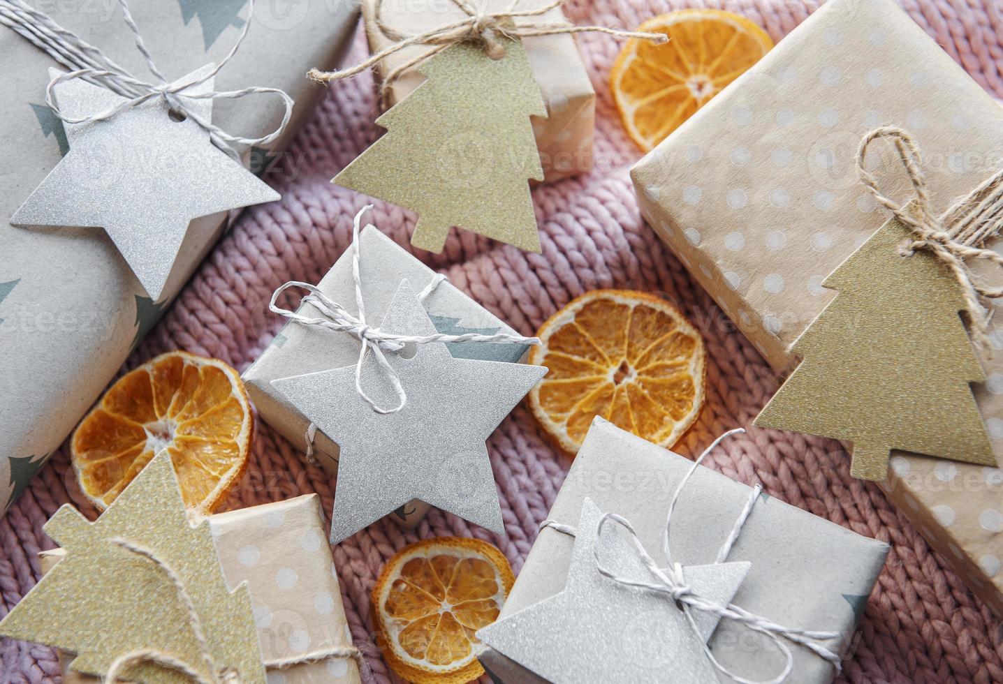 Christmas presents on pink knitted textile background. photo