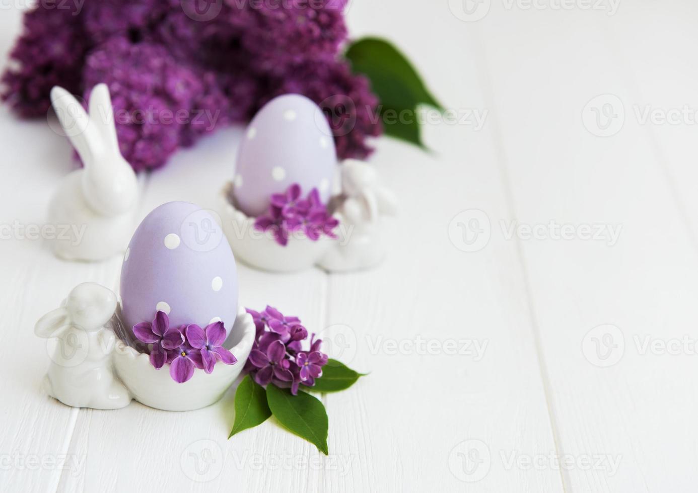 Spring lilac flowers and easter eggs photo