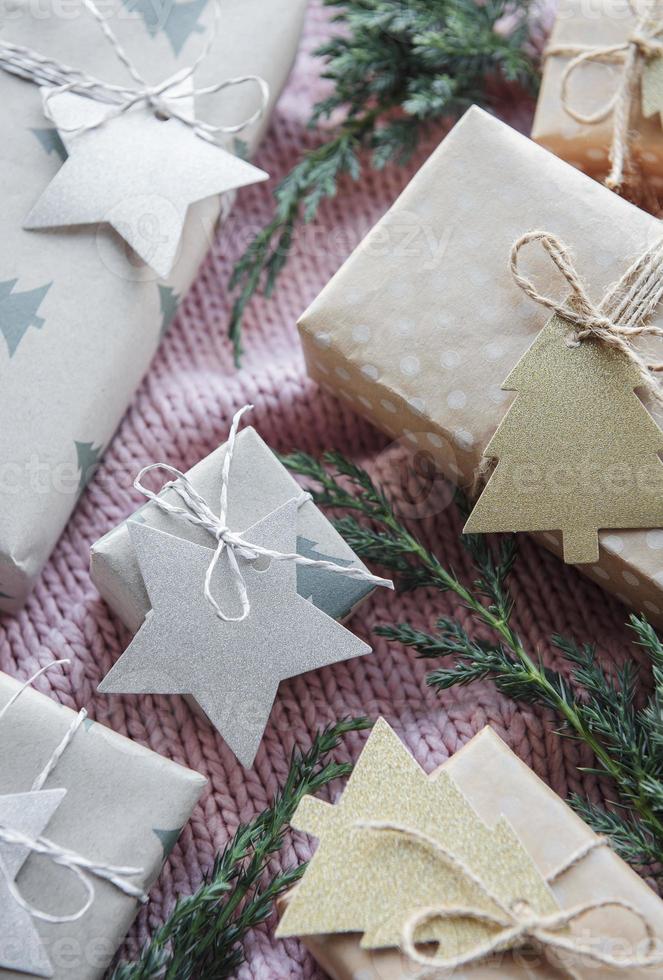 Christmas presents on pink knitted textile background. photo