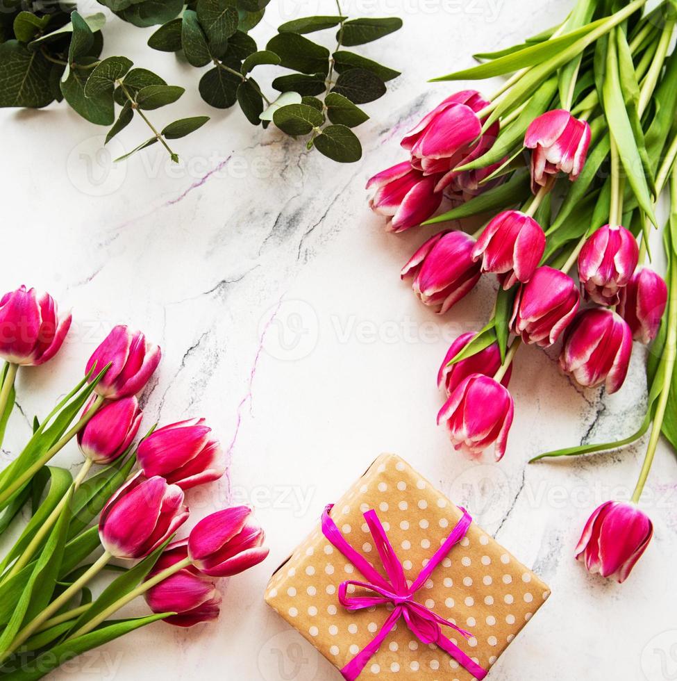 Pink spring tulips and gift box photo