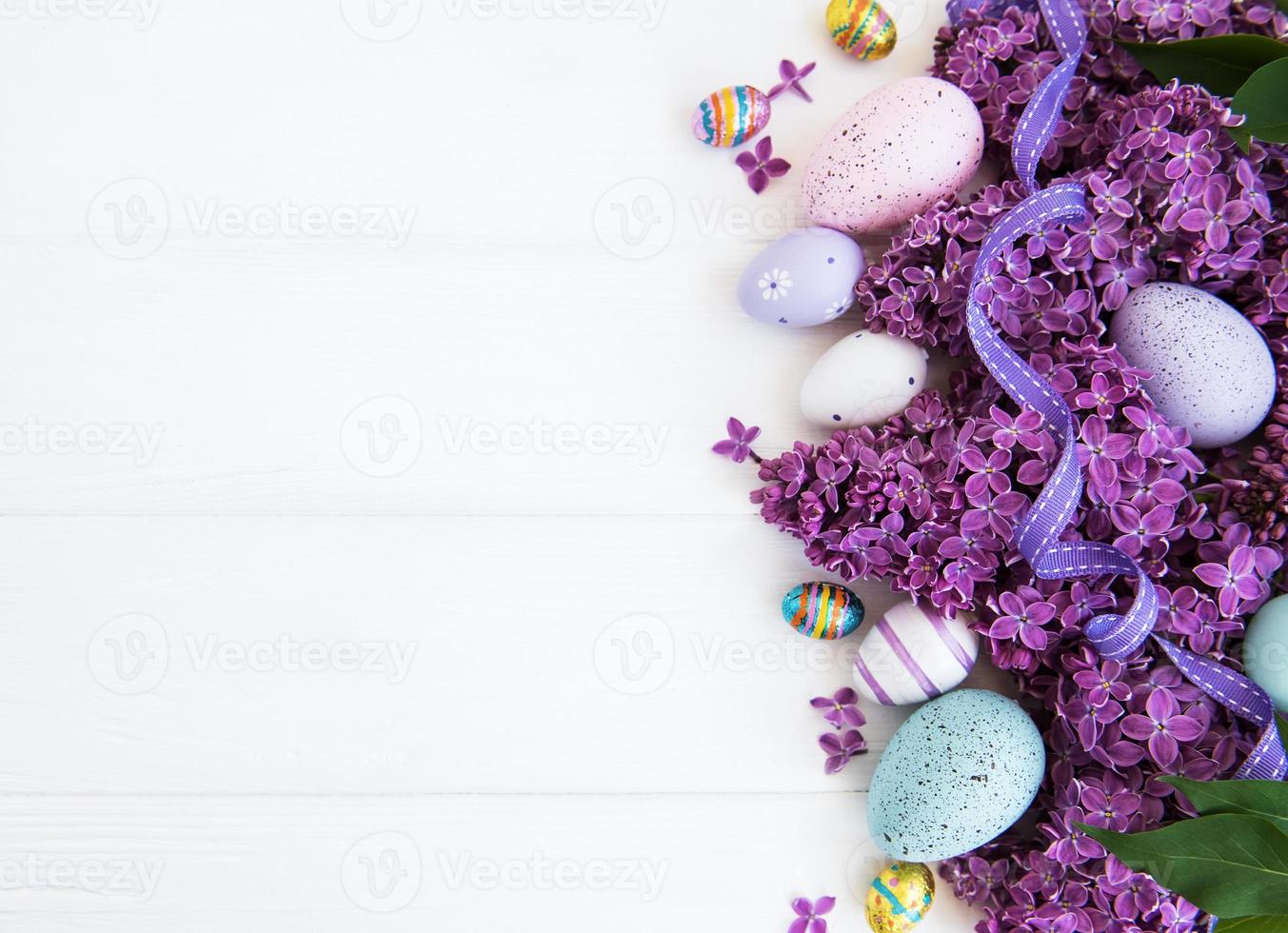 Spring lilac flowers and easter eggs photo