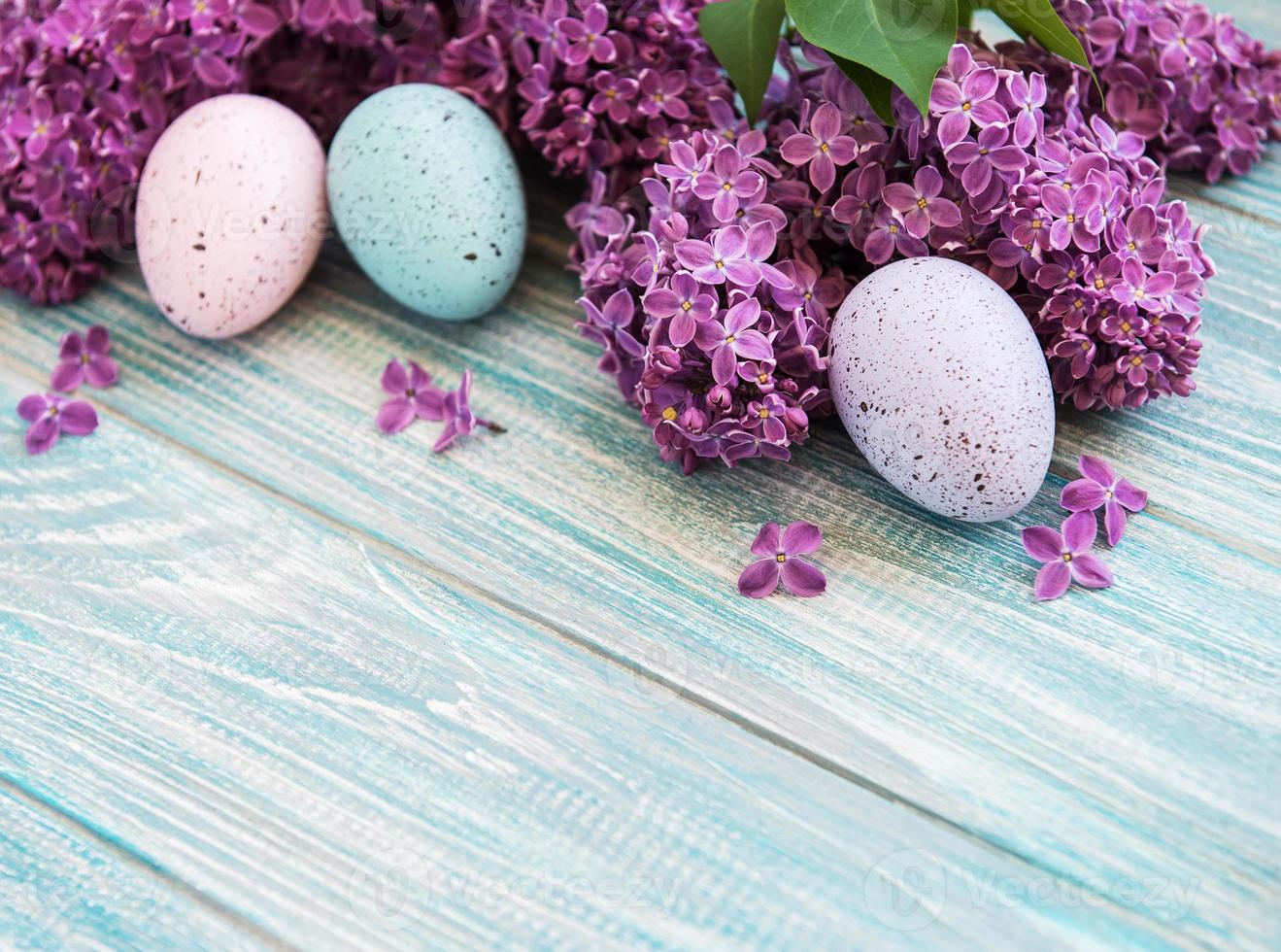 Spring lilac flowers and easter eggs photo