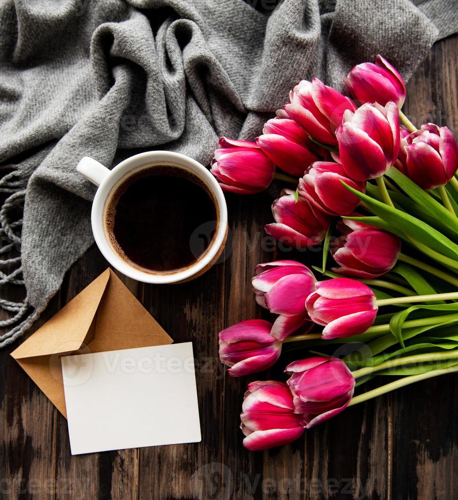 Cup of coffee and pink tulips photo