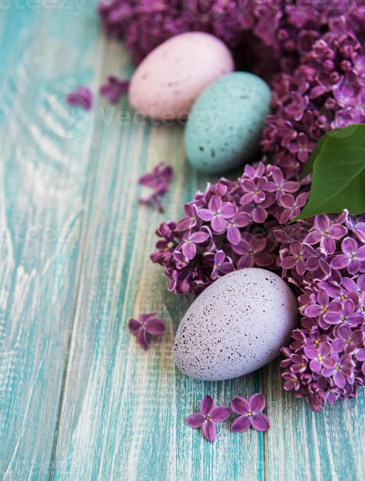 Spring lilac flowers and easter eggs photo